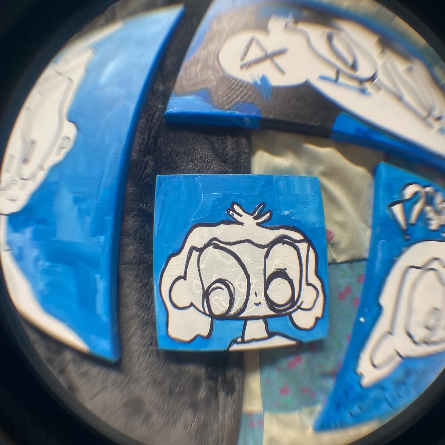 photograph of multiple paintings blue and white on canvas figural drawings